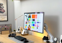 a-computer-monitor-sitting-on-top-of-a-wooden-desk.jpg a computer monitor sitting on top of a wooden desk
